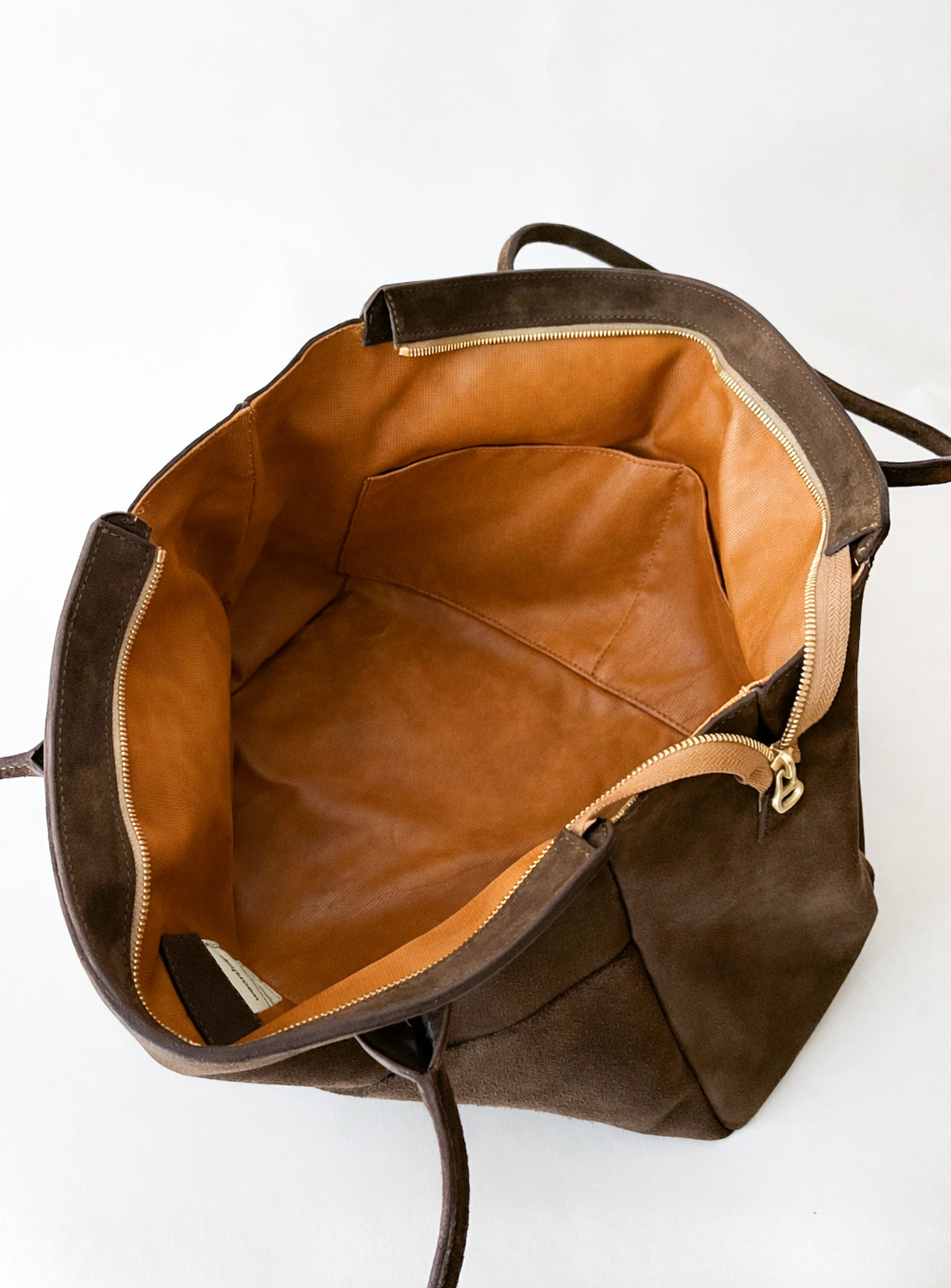 Brown leather work bag with two interior pockets, leather lining on a white background